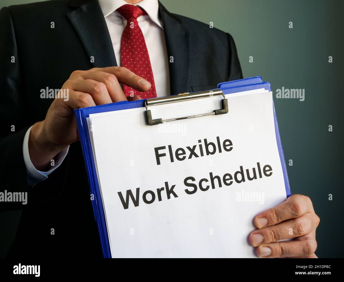 A manager shows Flexible Work Schedule in clipboard. Stock Photo