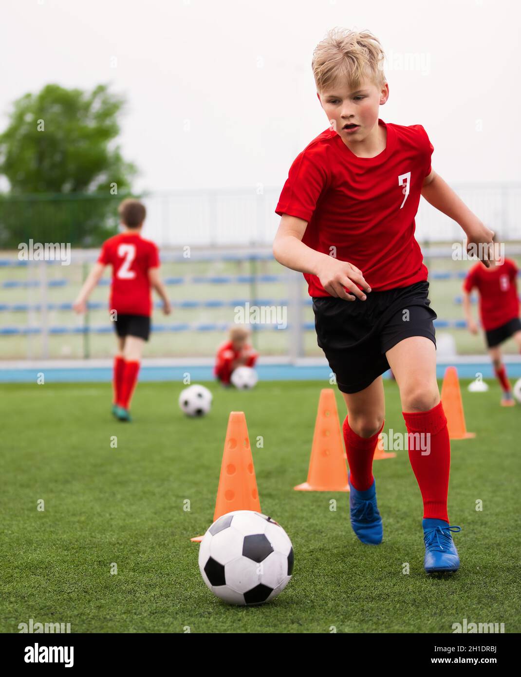 Soccer Boy on Training with Ball and Soccer Cones. Dribbling Drill