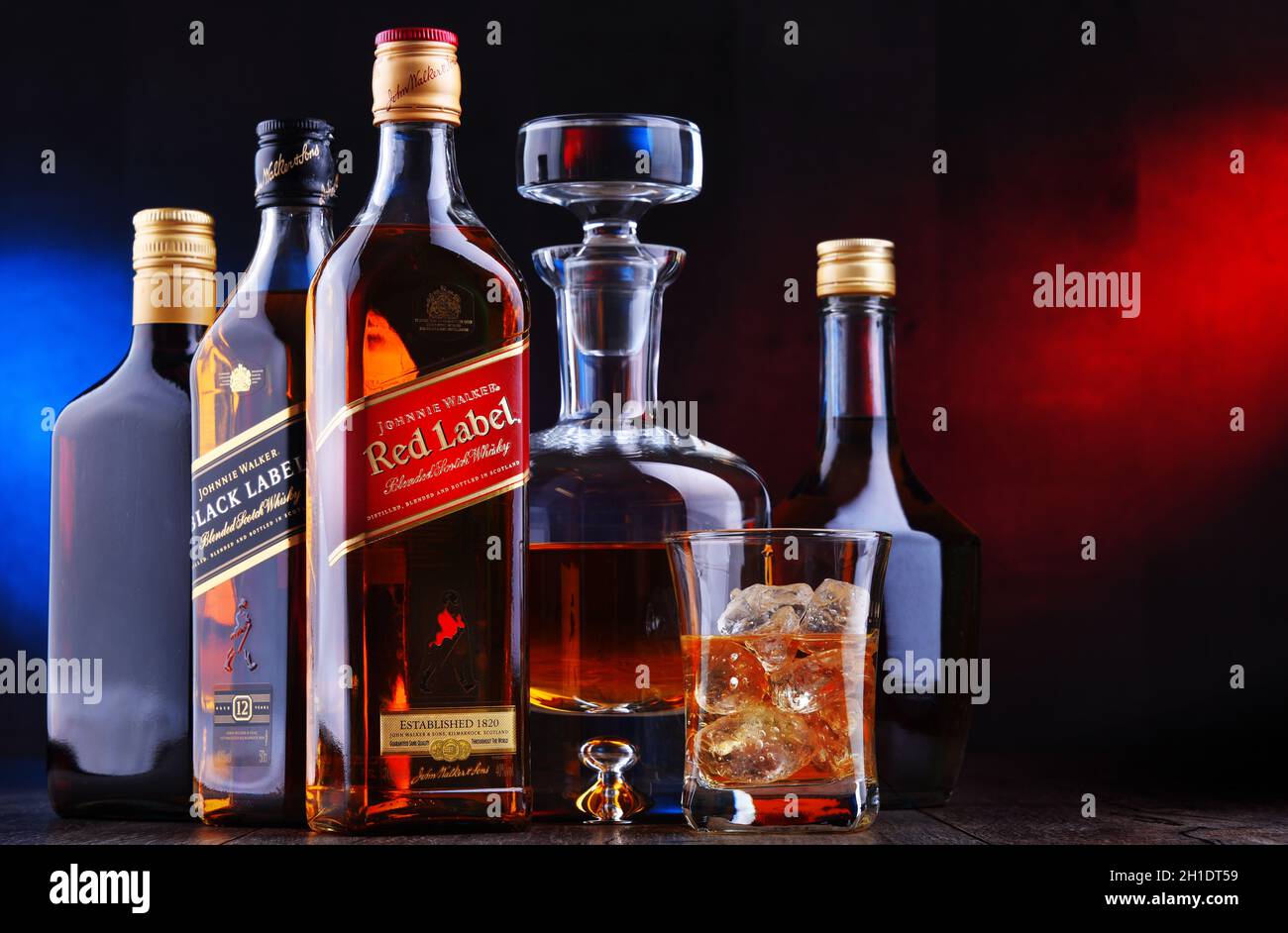 POZNAN, POL - APR 16, 2020: Bottles of Johnnie Walker Red Label and Black Label among other hard liquor drinks Stock Photo