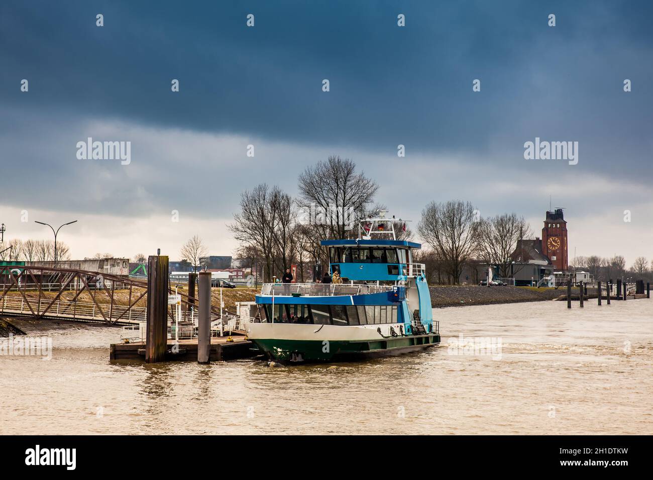 HAMBURG, GERMANY - MARCH, 2018: Ferry navigating on the Elbe river in a cold cloudy winter day in Hamburg Stock Photo