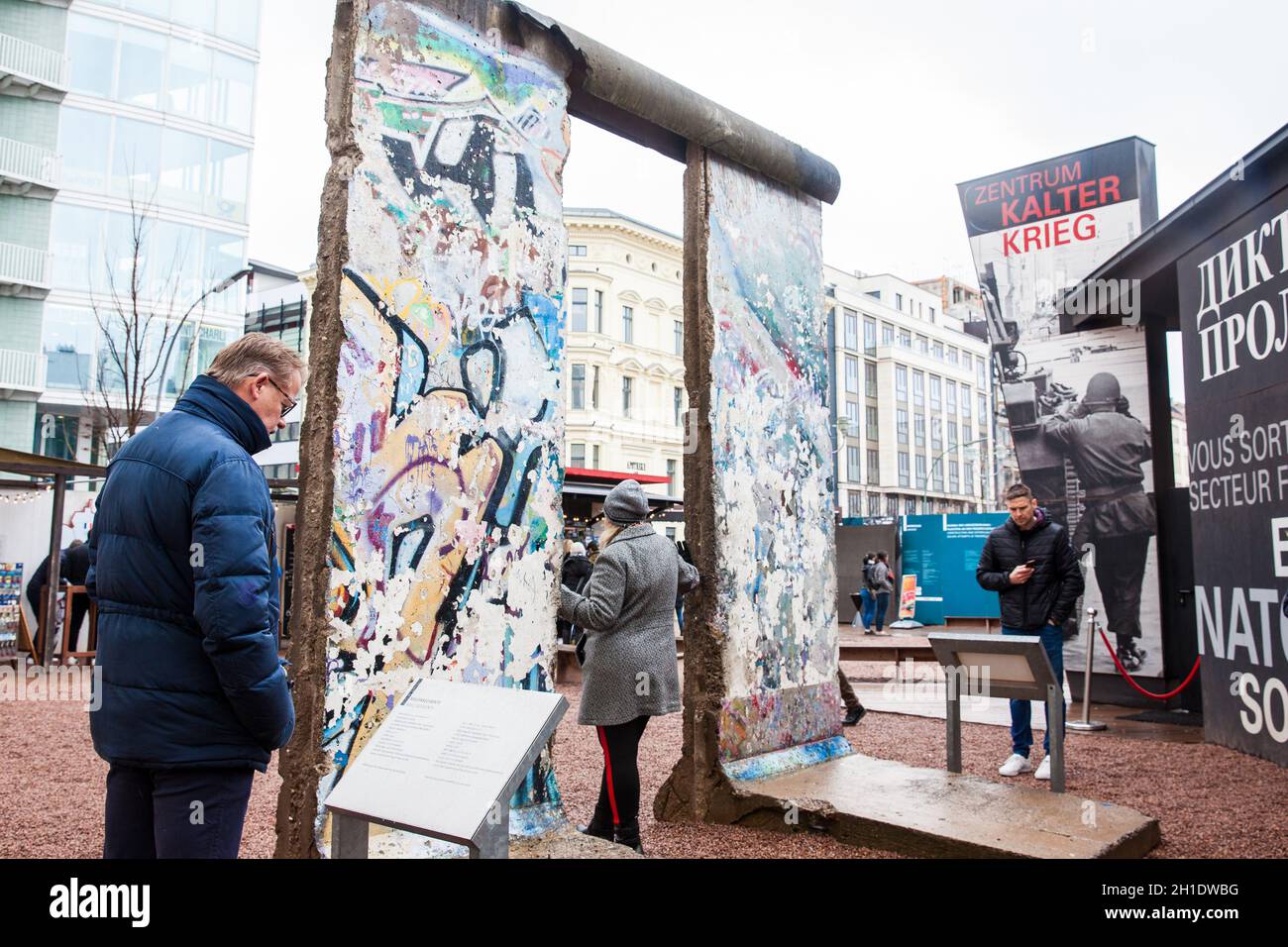 BERLIN, GERMANY - MARCH, 2018: Tourists looking at a piece of the Berlin Wall at the  entrance of the BlackBox Cold War Museum Stock Photo