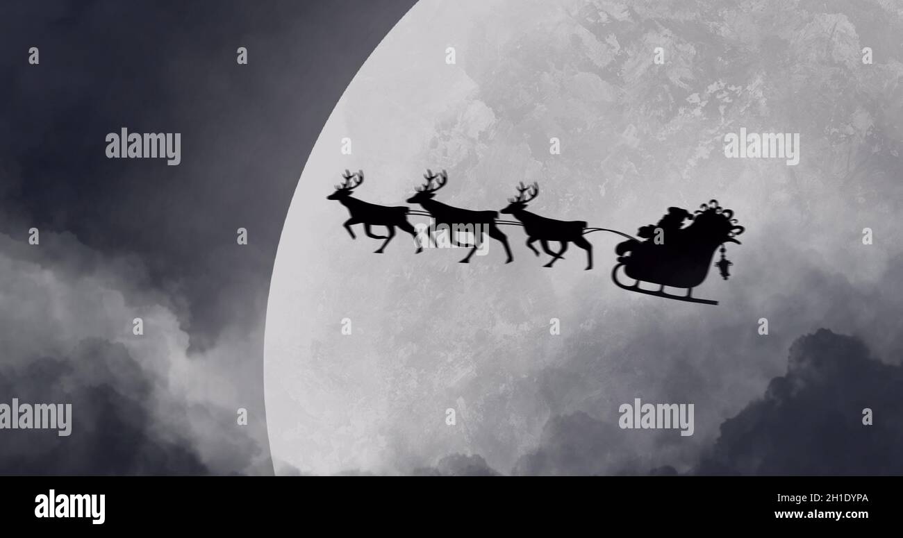 Silhouette of Santa Claus in sleigh being pulled by reindeers against moon Stock Photo