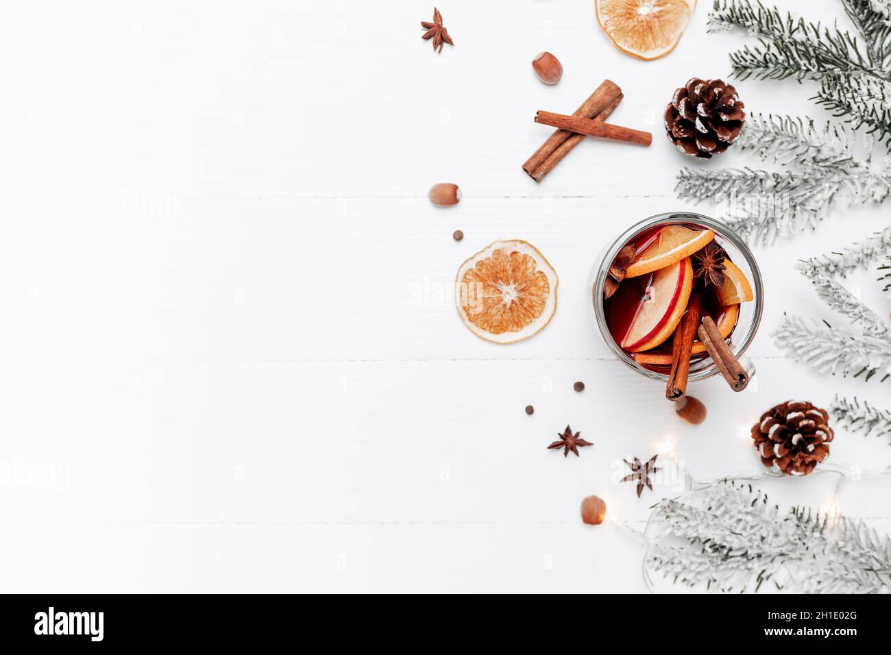 Christmas banner flat lay with glass cup of Mulled Wine, gift box, decorations Stock Photo