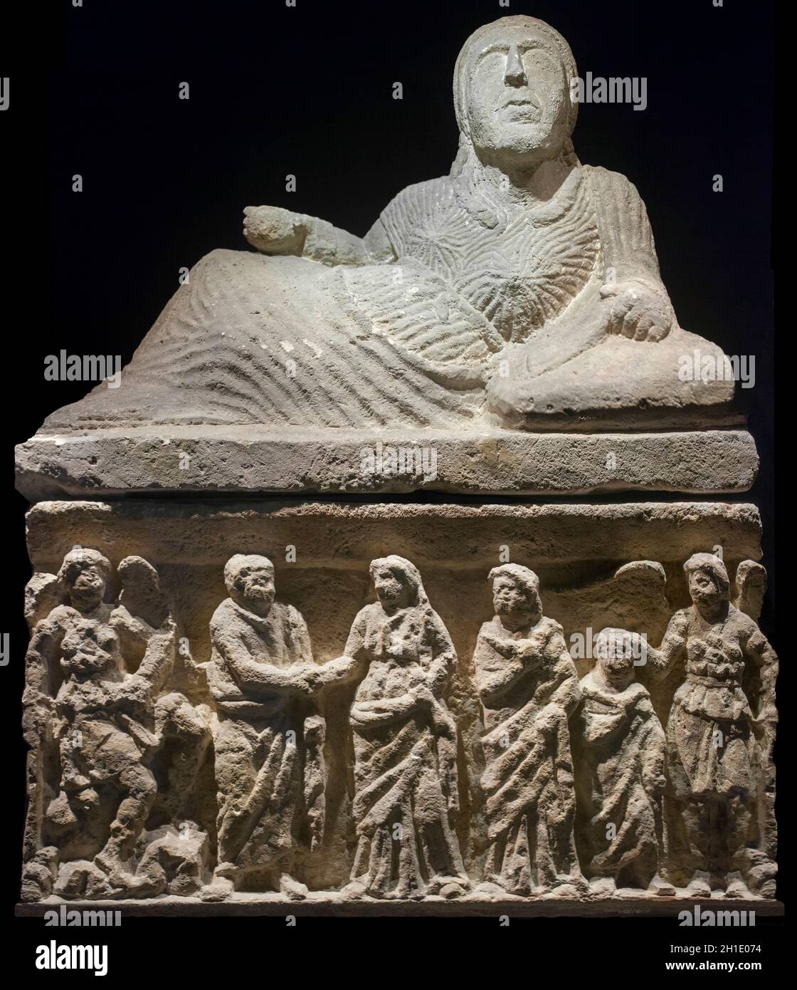 Barcelona, Spain - Dec 27th, 2019: Etruscan cineray urn on podium. Top with reclined female figure sculpted and podium or box with relief of matrona s Stock Photo