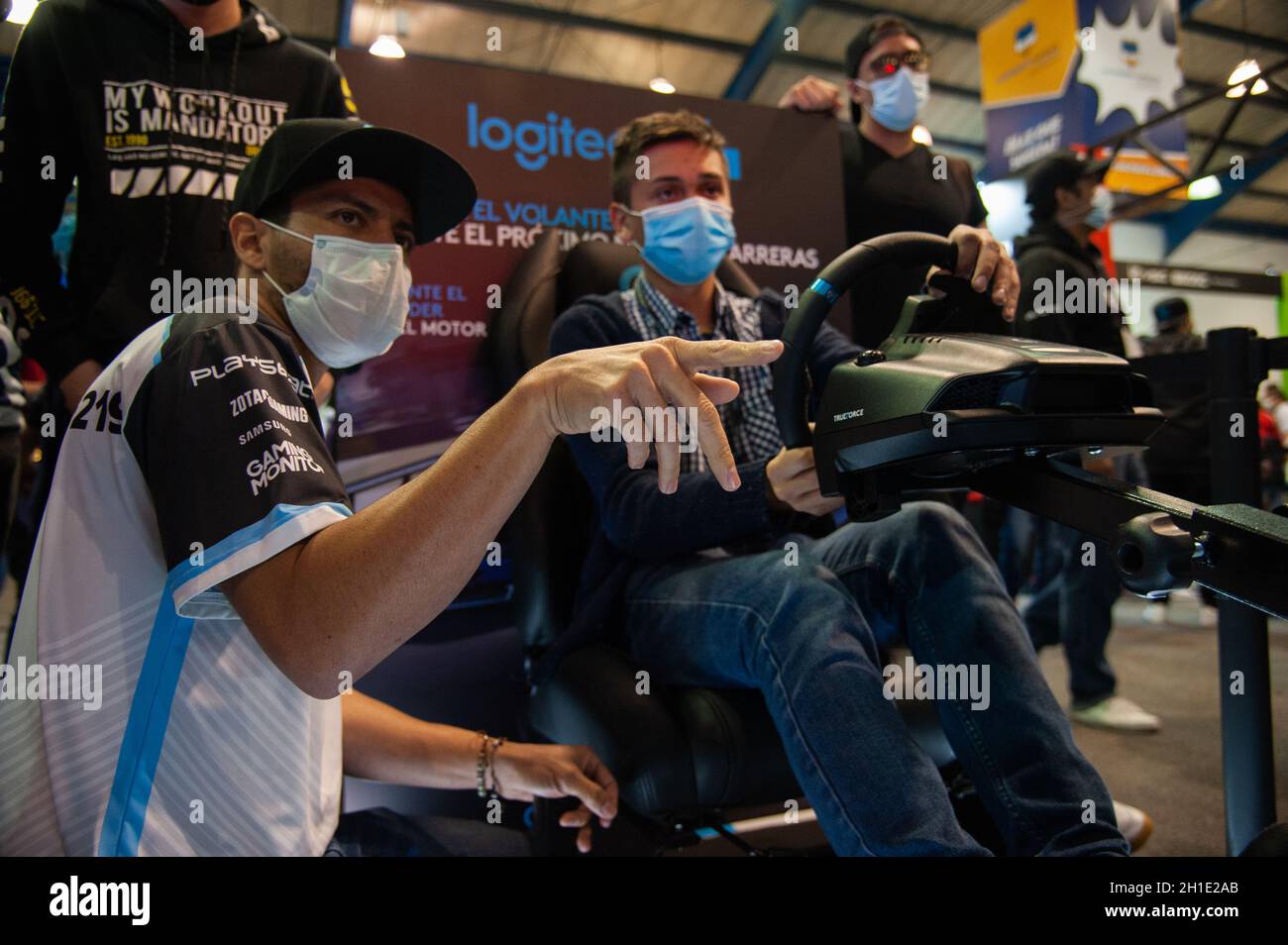 Logitech Simulation Driving People play and enjoy a driving simulator from Logitech during the ...