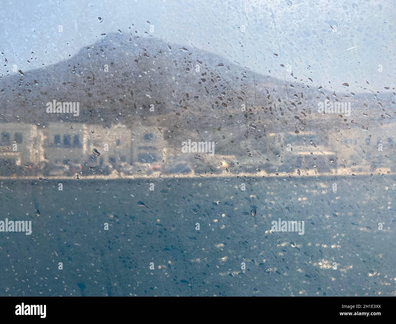 Melancholy coastal view seen through a window boat, Greece island, cyclades, Travel background Stock Photo