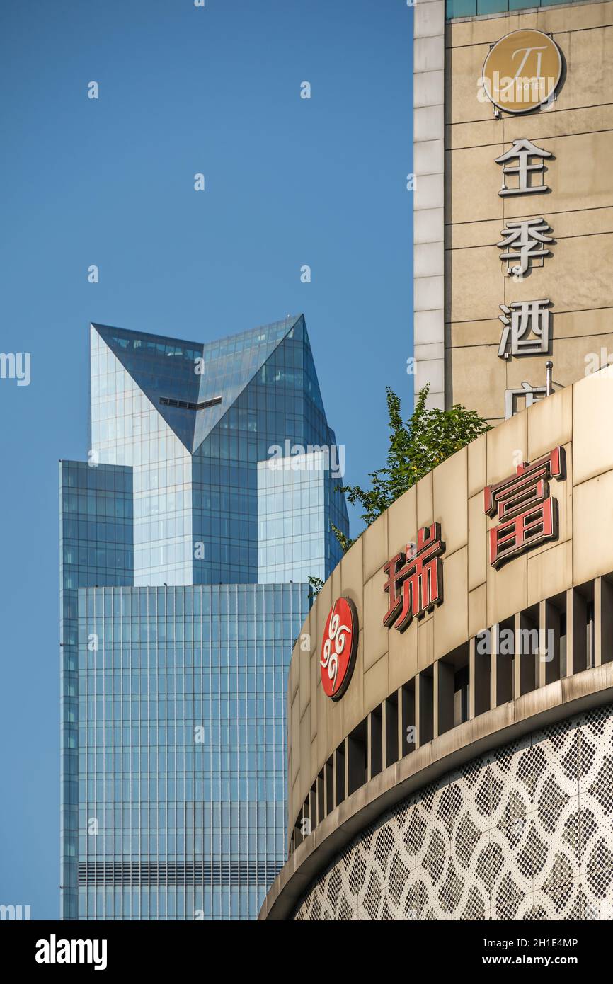 Chongqing, China -  August 2019 : Facades and logos on top of the modern commercial and business buildings in the Jiefangbei district in the downtown Stock Photo