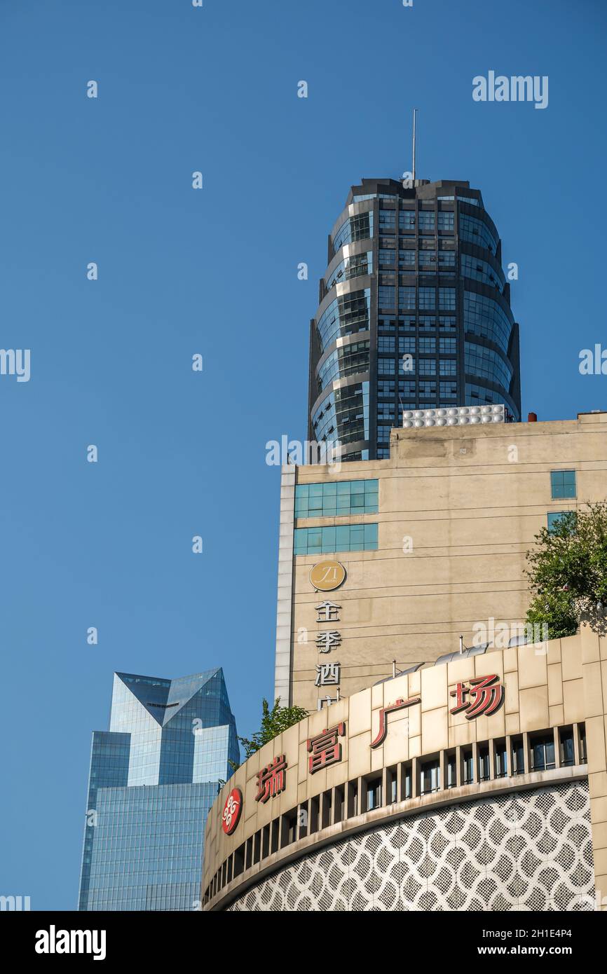 Chongqing, China -  August 2019 : Facades and logos on top of the modern commercial and business buildings in the Jiefangbei district in the downtown Stock Photo