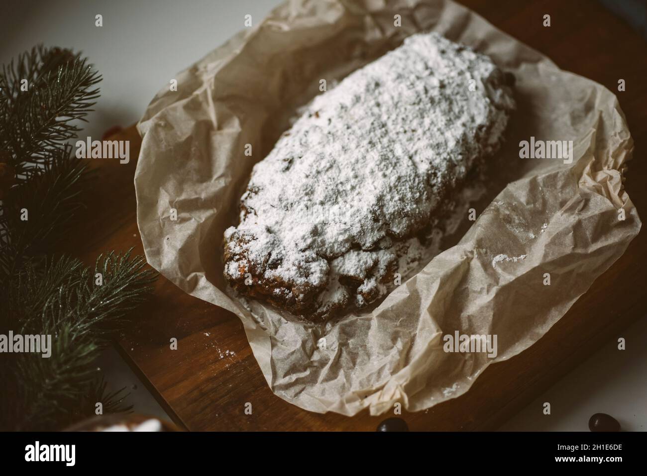Appetizing Christmas pastries, stollen on a wooden board with Christmas decor Stock Photo