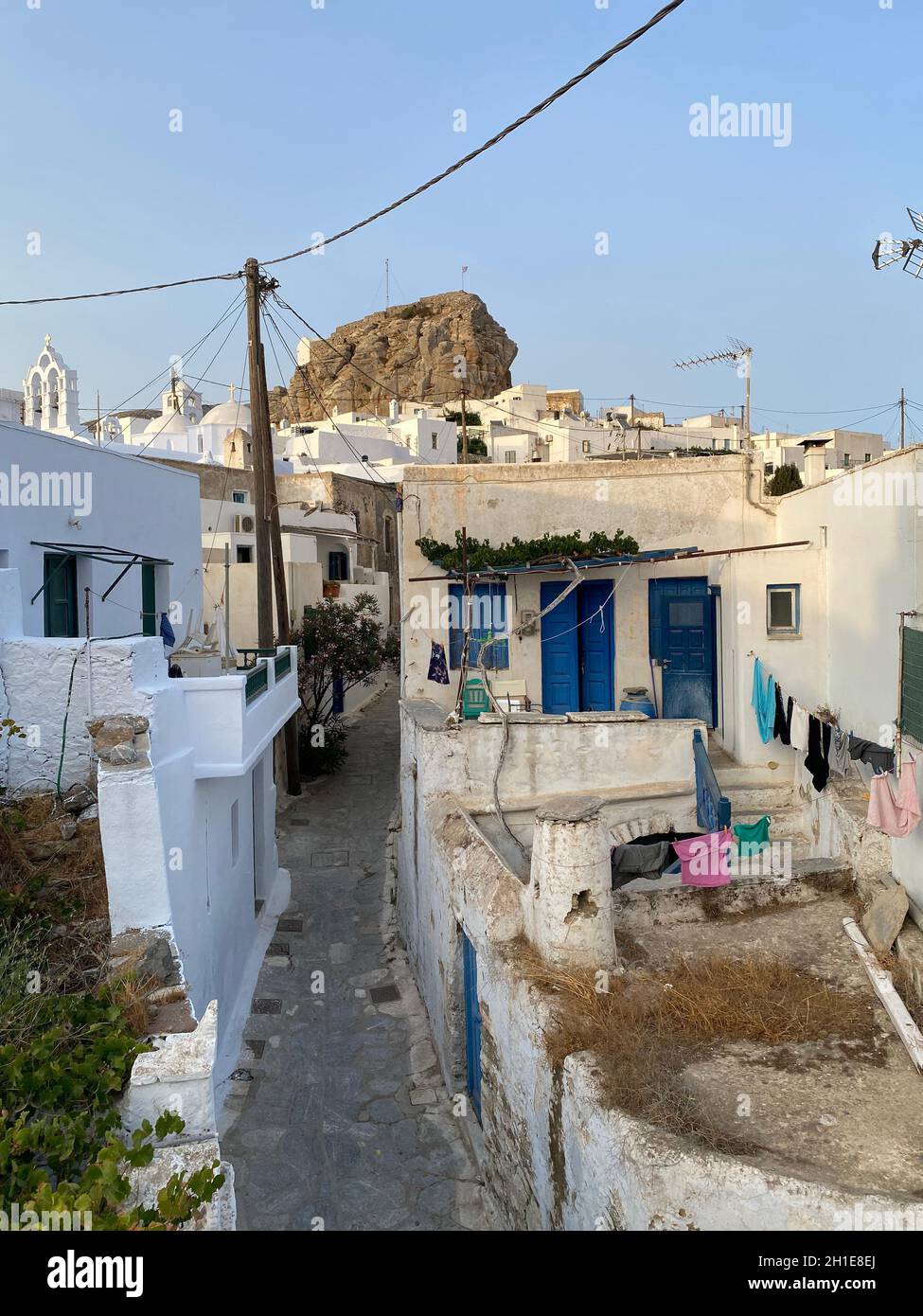 Pedestrian street of Greek Chora village built around a large rock on Amorgos island, Aegean Sea, Cyclades, Greece Stock Photo