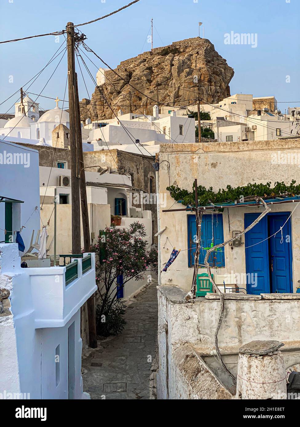 Pedestrian street of Greek Chora village built around a large rock on Amorgos island, Aegean Sea, Cyclades, Greece Stock Photo