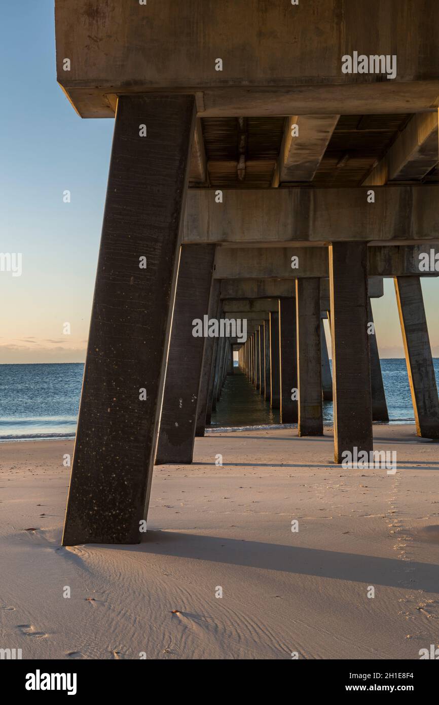 Substructure of Gulf State Park fishing pier at dawn creates interesting patterns on the beach of Gulf Shores, Alabama Stock Photo