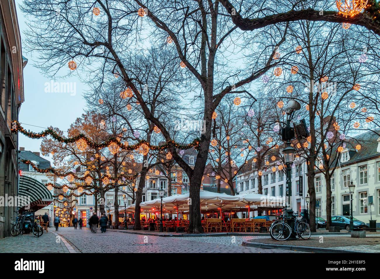 MAASTRICHT, THE NETHERLANDS - NOVEMBER 22, 2016: Dinner tables of bars and restaurants with christmas lights on the famous Onze Lieve Vrouweplein Stock Photo