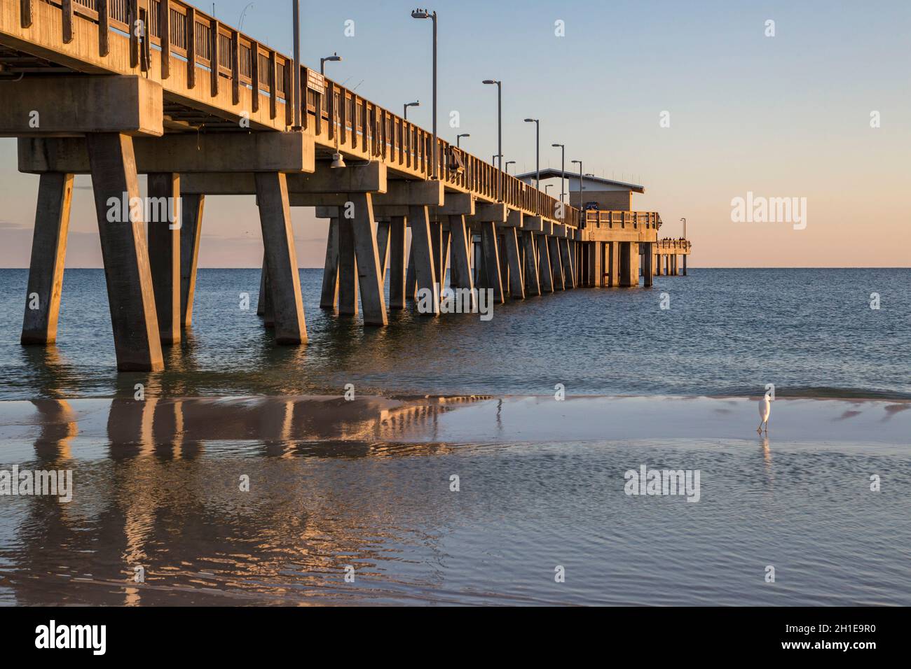 Gulf State Park fishing pier at dusk on the beach of Gulf Shores