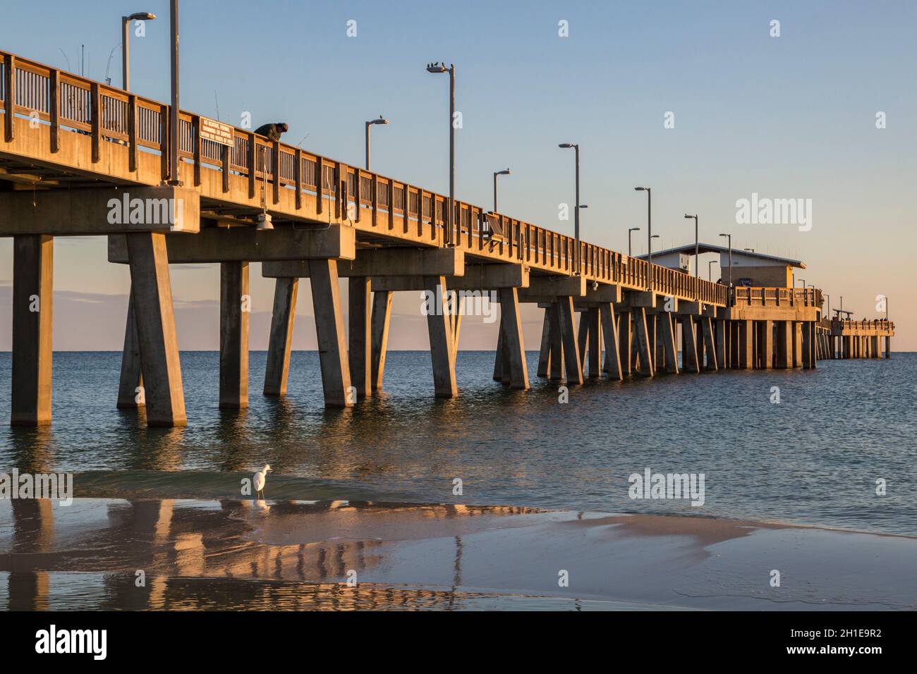 Gulf State Park fishing pier at dusk on the beach of Gulf Shores