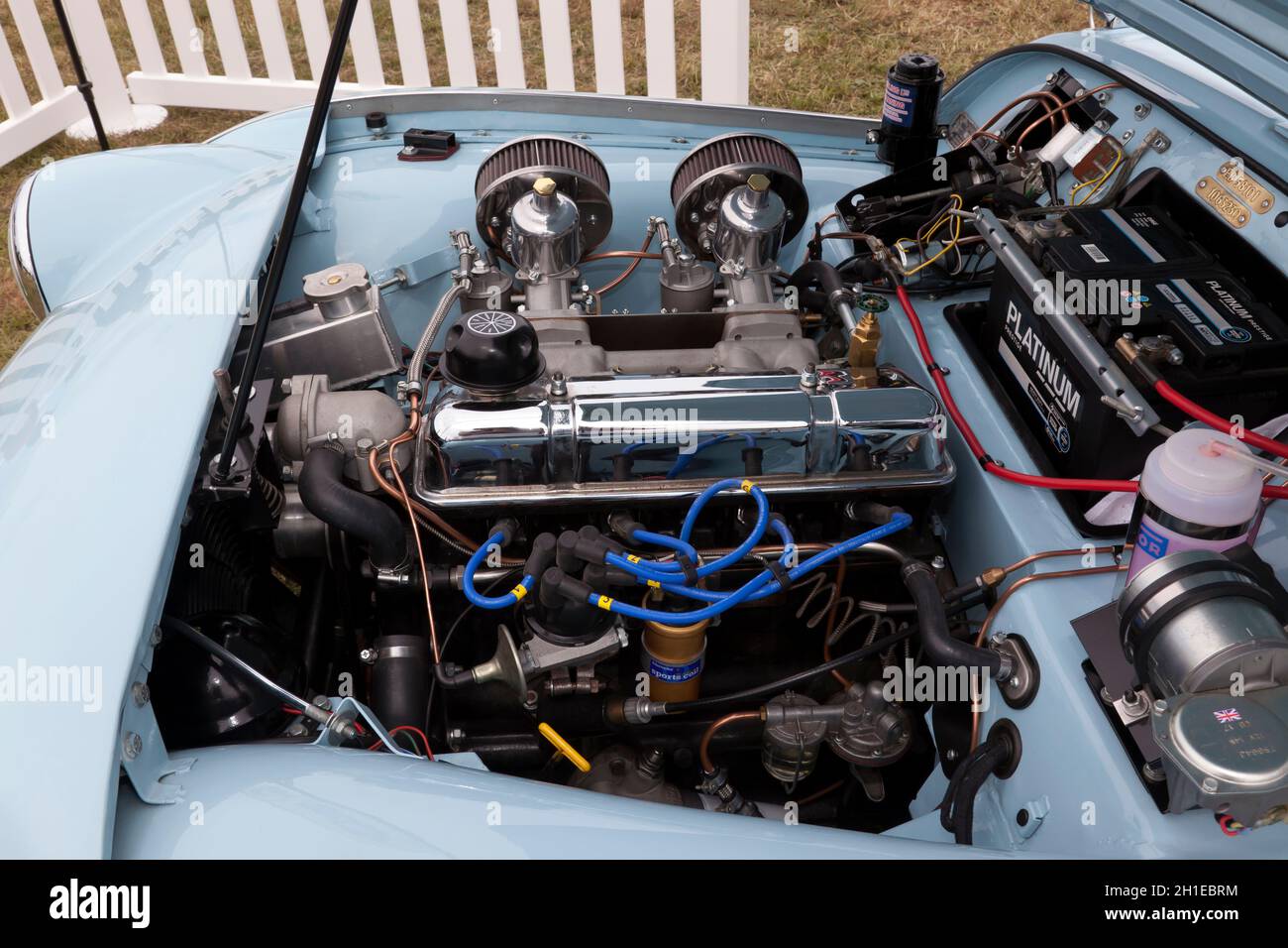 Close-up view of the Engine of a Blue, 1959, Triumph TR3, on display, at the 2021 London Classic Car Show Stock Photo