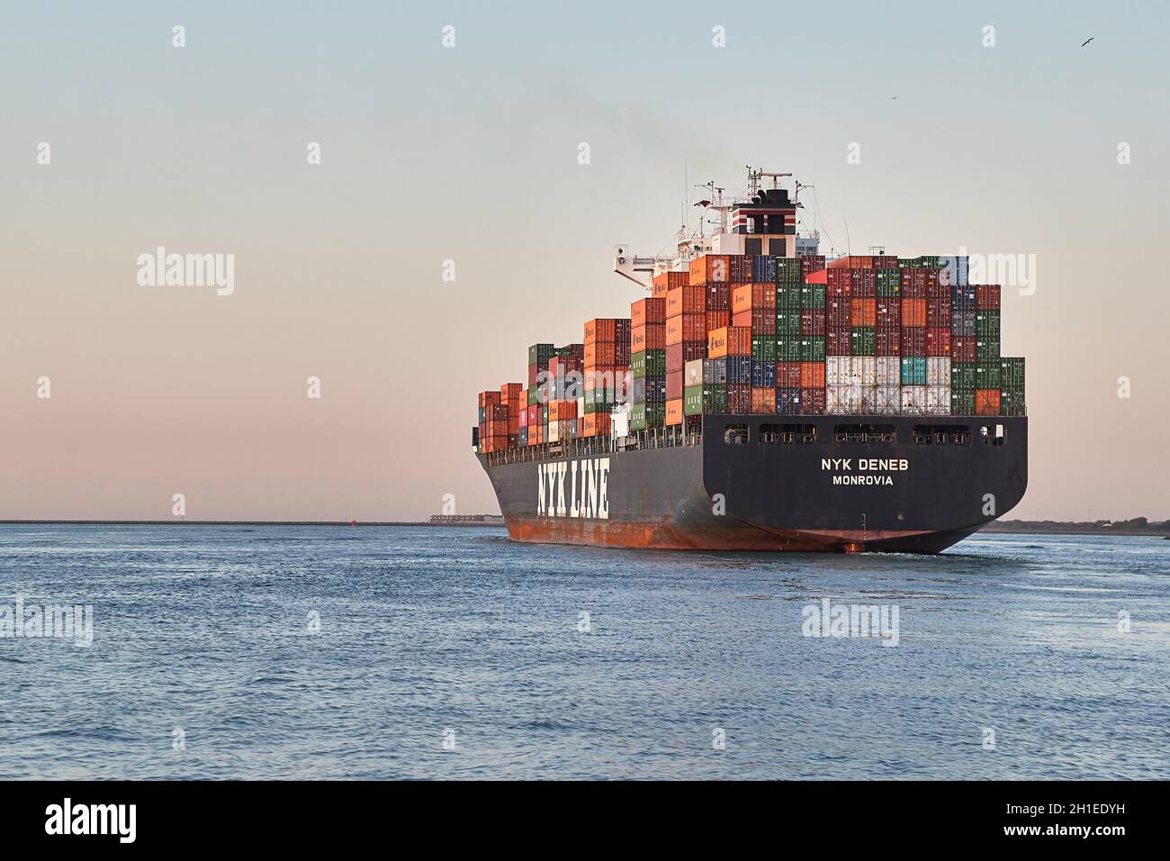 ROTTERDAM, THE NETHERLANDS - CIRCA 2019: Container ship heading out to the North Sea from the Port of Rotterdam. Vessel of Nyk Line, Nippon Yusen Japa Stock Photo
