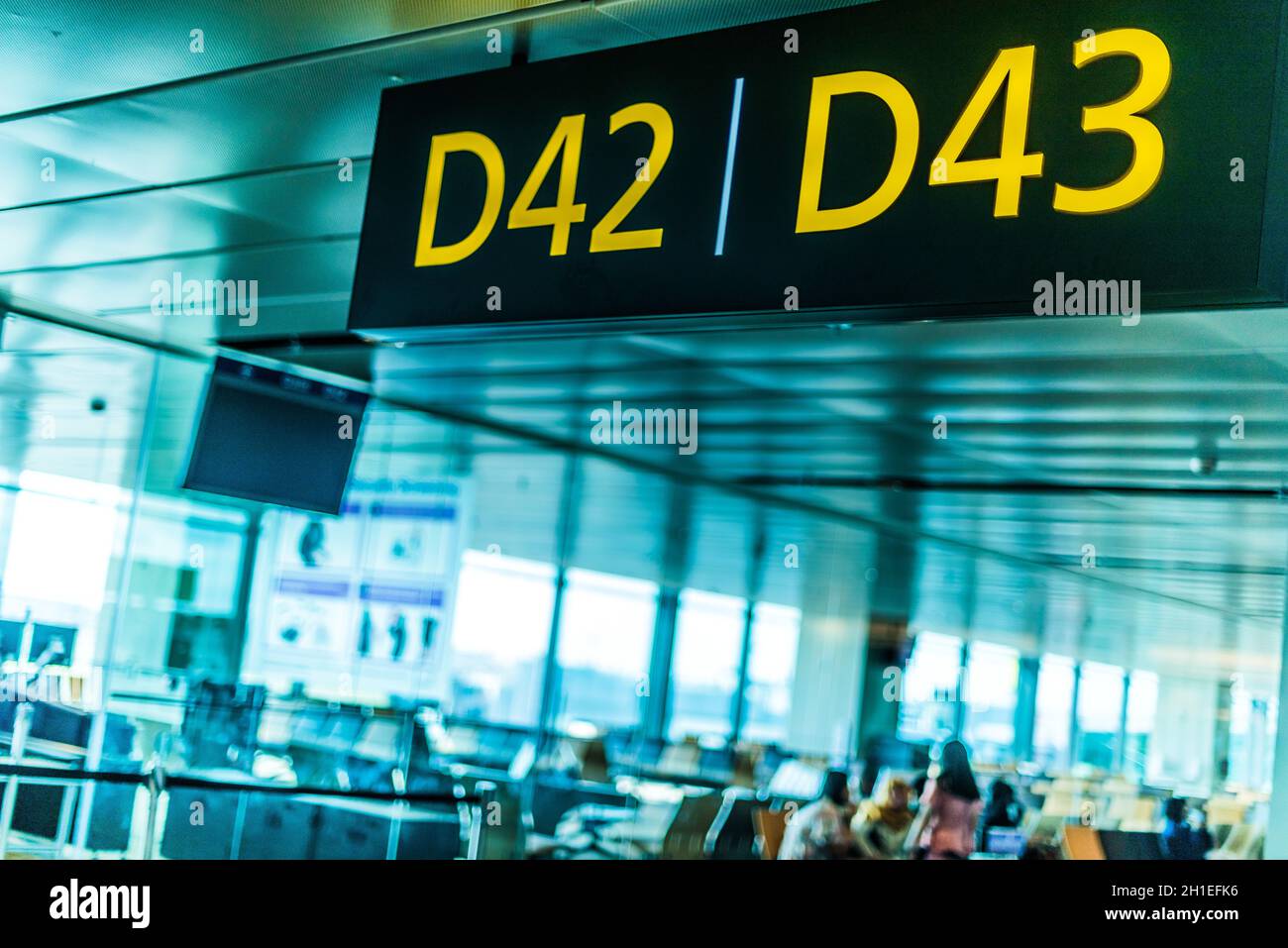 Interior of airport terminal with the sign depicting gate number Stock