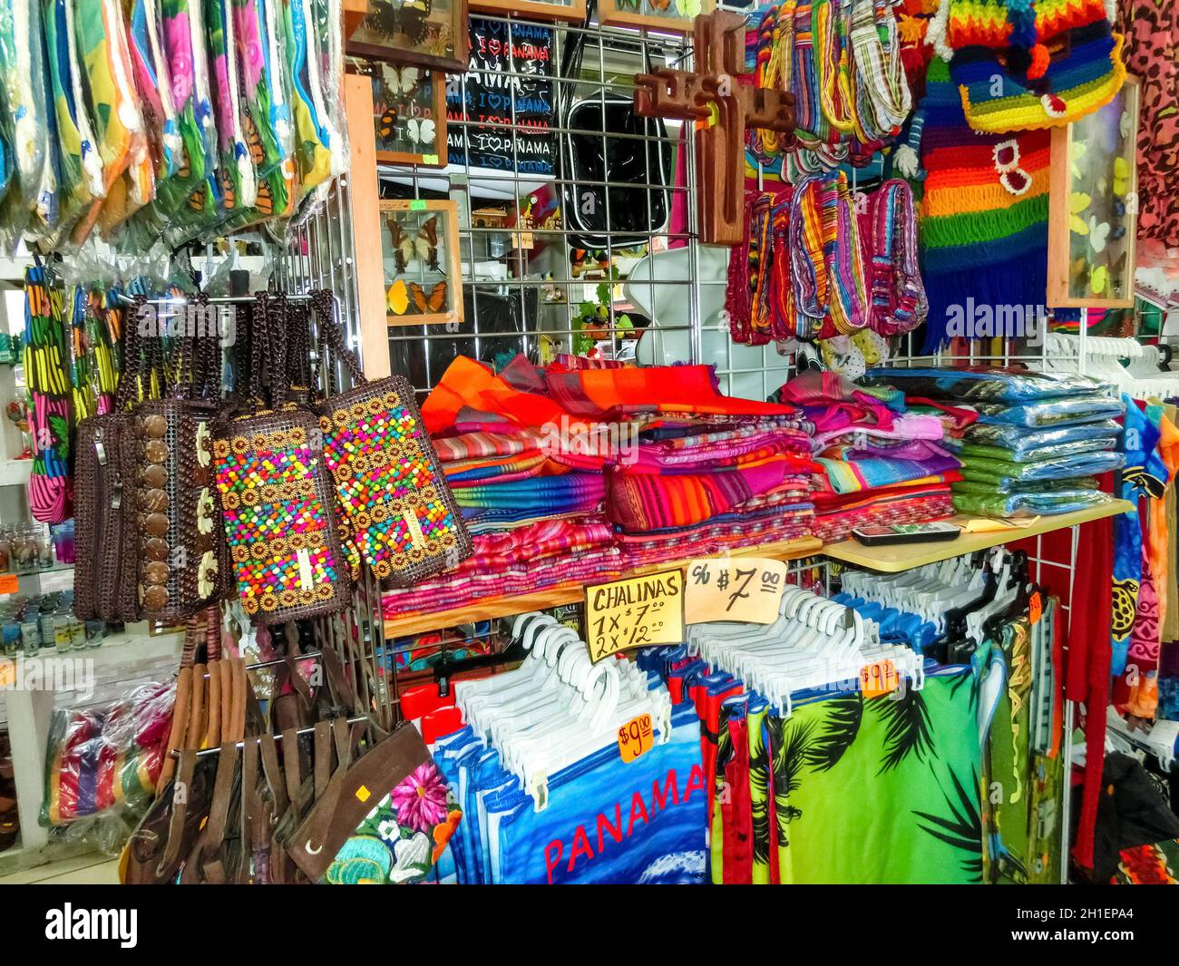 Ethnic souvenirs, baseball caps, bags with various pattern hanging in ...