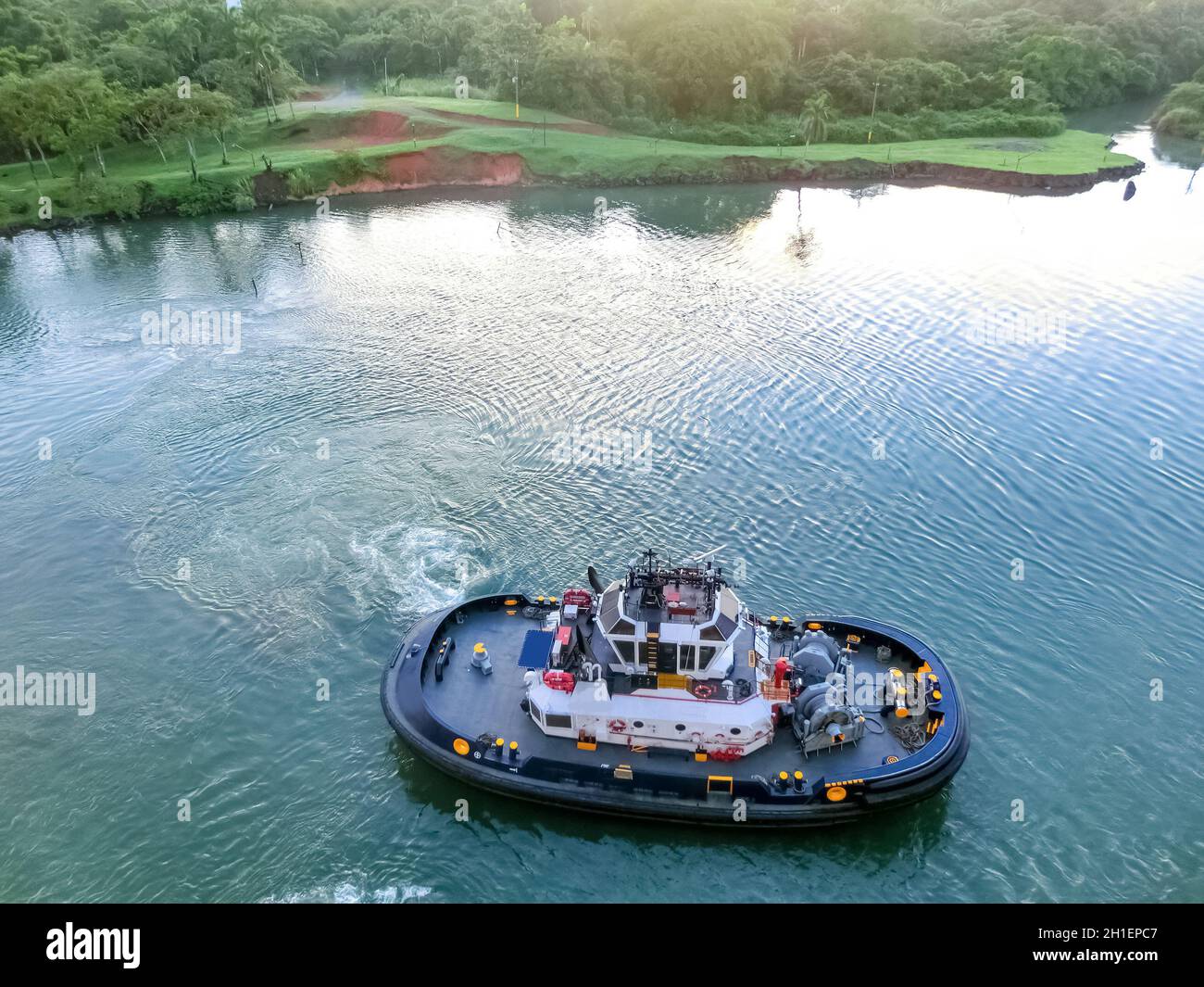 The patrol Panamanian tug boat guiding ships through the locks. Stock Photo