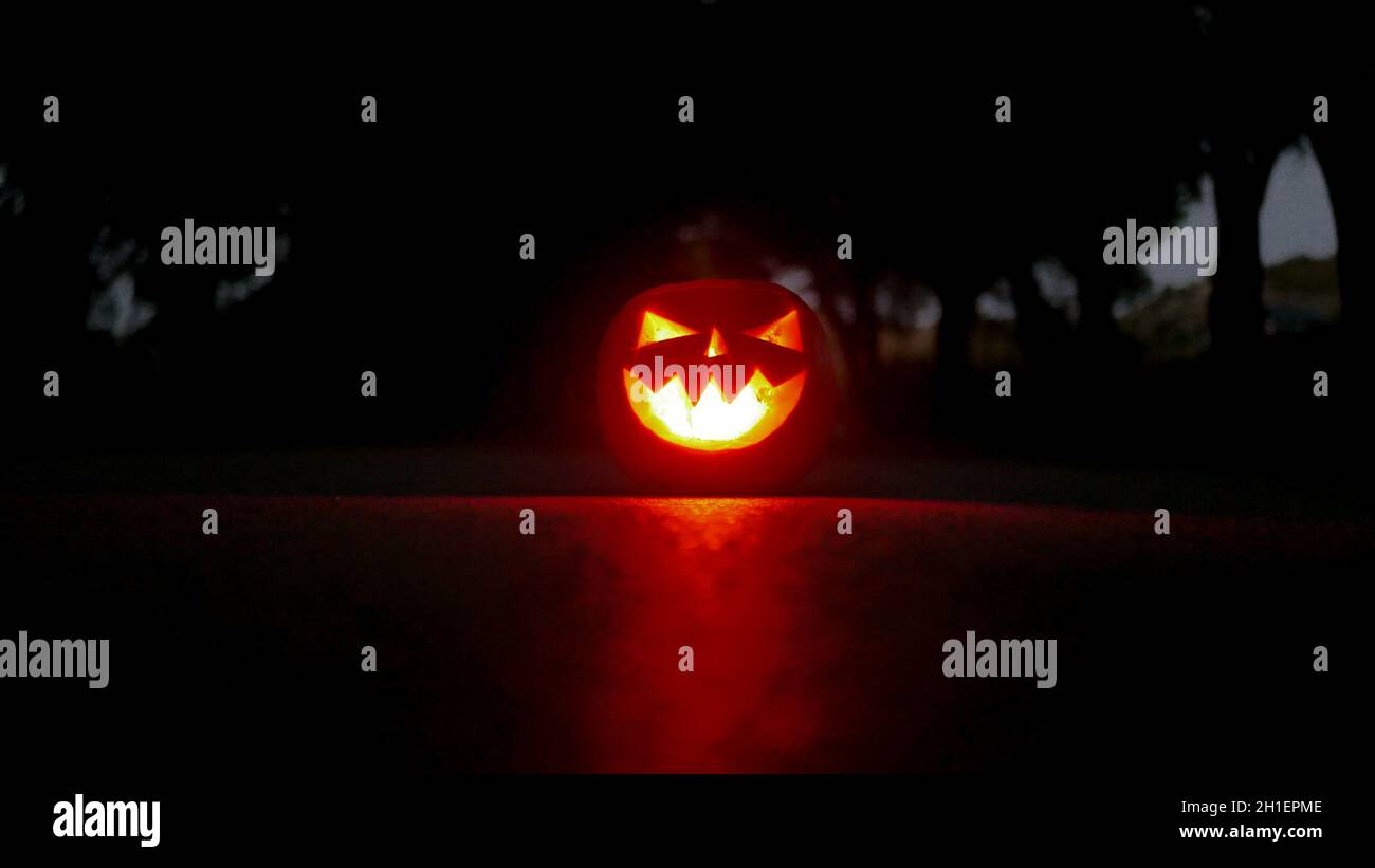 Burning pumpkin with a carved face as a symbol of Halloween Stock Photo ...