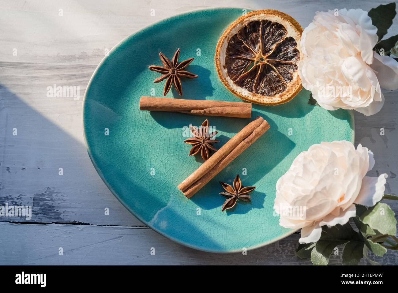 plate with several spices used for mulled wine and other cold weather drinks decorated with peony flowers Stock Photo