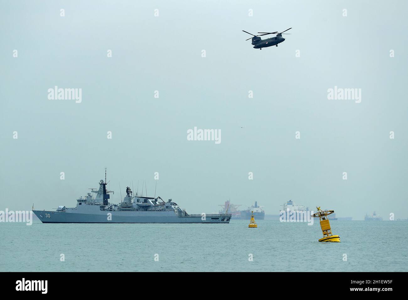 Kd Lekiu 30 From The Royal Malaysian Navy And A Republic Of Singapore Air Force Chinook Helicopter Seen During The Five Power Defence Arrangements Fpda 50th Anniversary Flypast And Naval Vessel Display