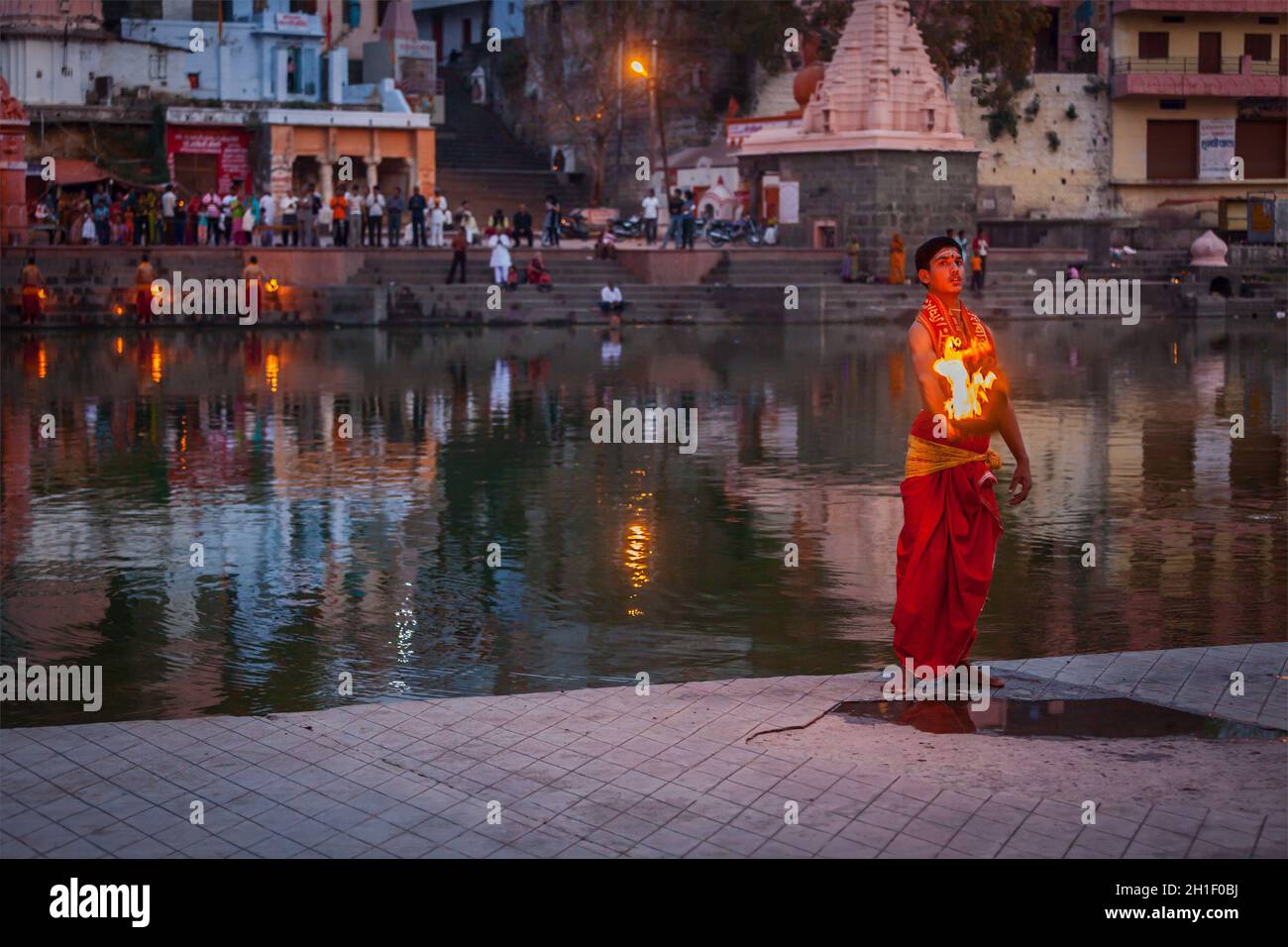 UJJAIN, INDIA - APRIL 23, 2011: Brahmin performing Aarti pooja ceremony on bank of holy river Kshipra. Aarti is Hindu religious ritual of worship, par Stock Photo