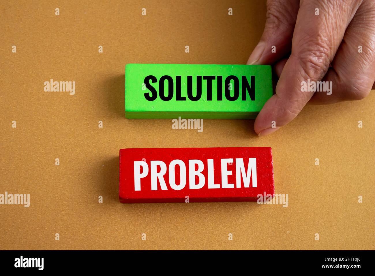 Hand holding wooden blocks with problem and solution written on it. Concept of solving problems. Stock Photo