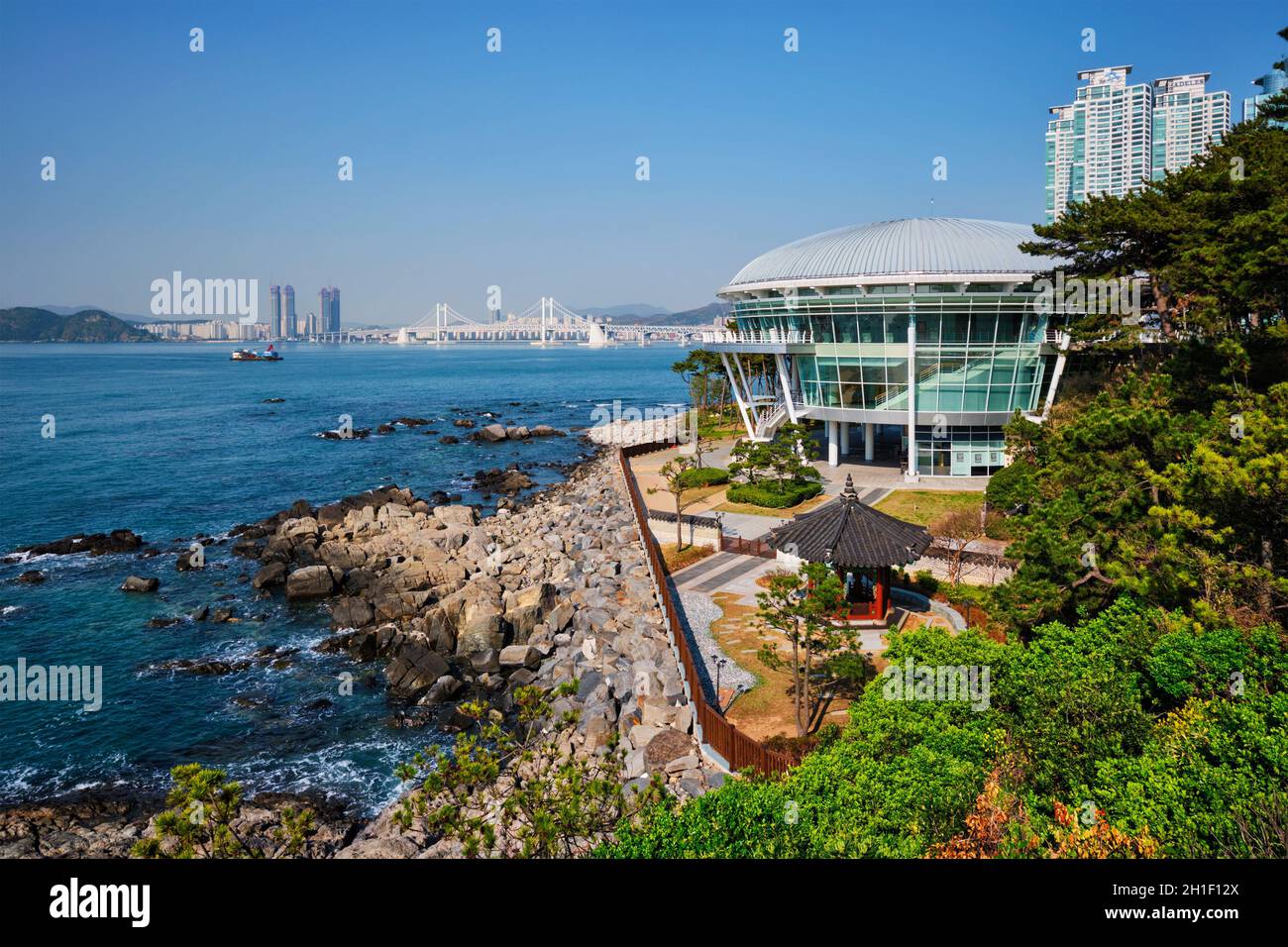 BUSAN, SOUTH KOREA - APRIL 13, 2017: Nurimaru APEC House on Dongbaek island and Gwangan bridge in Busan, South Korea Stock Photo
