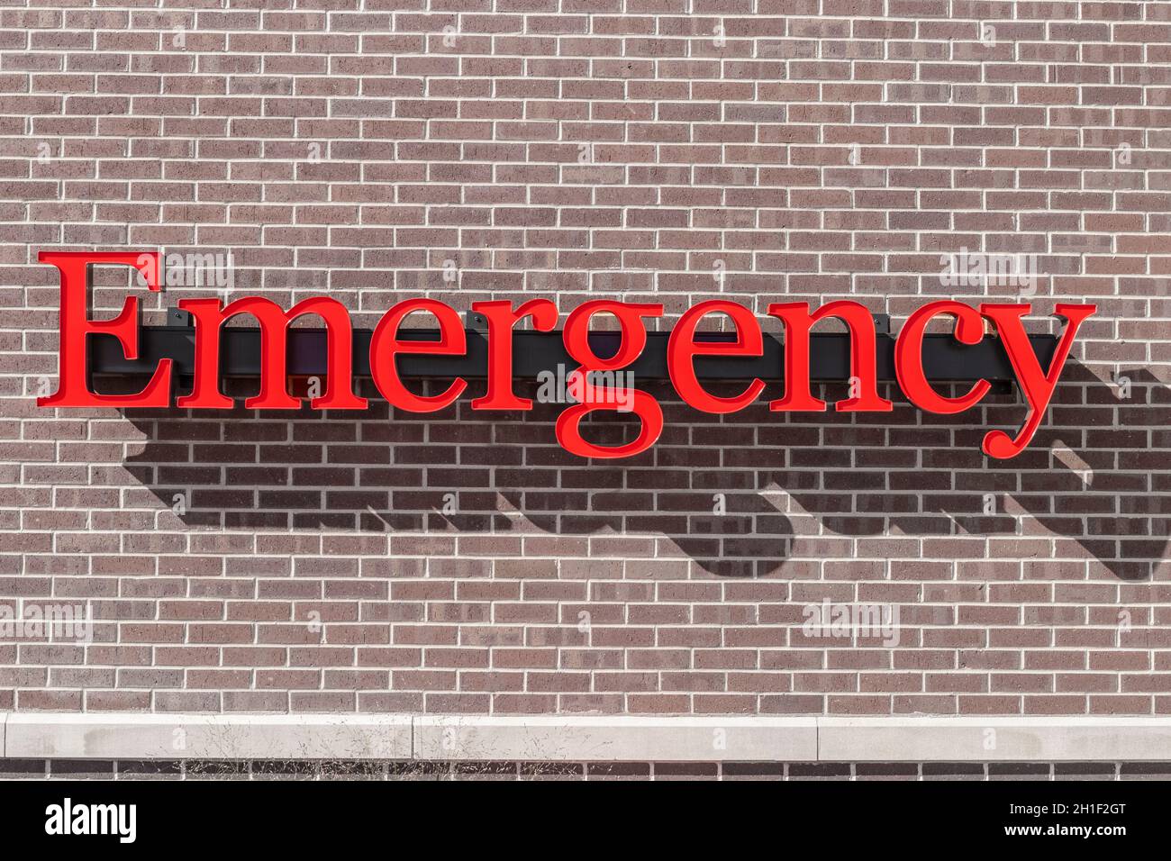 Emergency Entrance Sign for a Local Hospital in alert red. Stock Photo