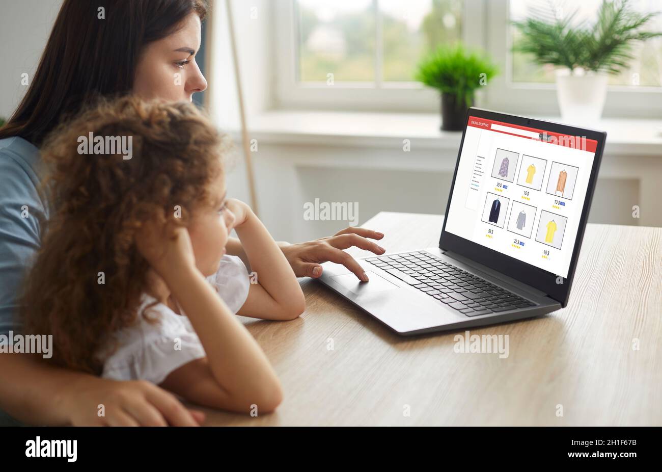 Mother and child shopping for new clothes in clothing store