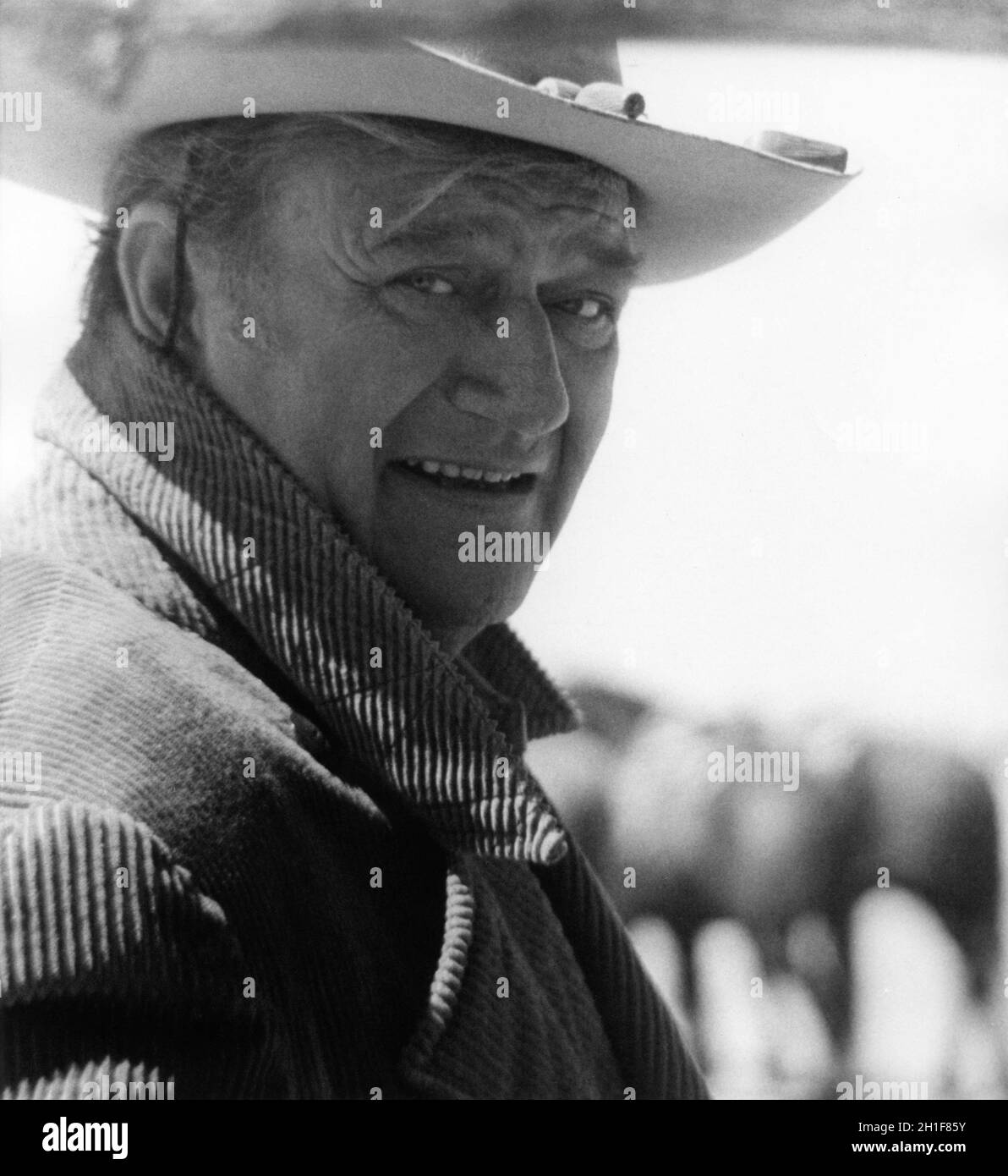 JOHN WAYNE portrait on set location candid during filming of THE COWBOYS 1972 director MARK RYDELL novel William Dale Jennings music John Williams costume design Anthea Sylbert Sanford Productions / Eaves Movie Ranch / Warner Bros. Stock Photo