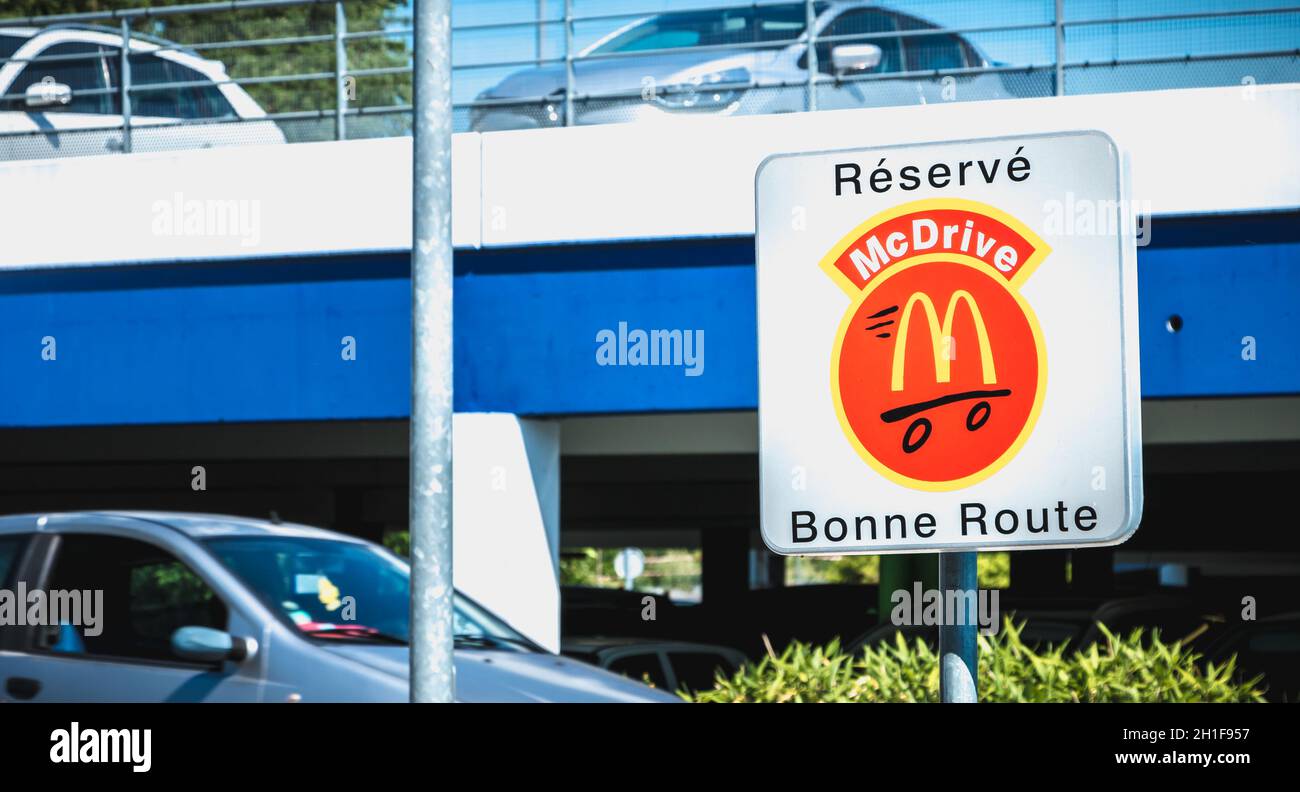 Libourne, France - May 26, 2017: Road sign indicating a place reserved for McDrive customers in the parking lot of a McDonald s restaurant on a spring Stock Photo