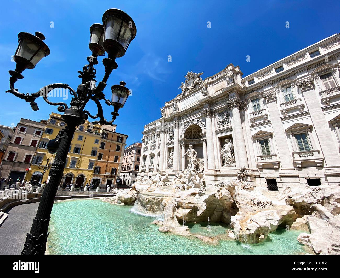 Rome, Italy, May 25th 2020: The Trevi Fountain in Rome with the first tourists after the lockdown due to the coronavirus pandemic. Access to the fount Stock Photo