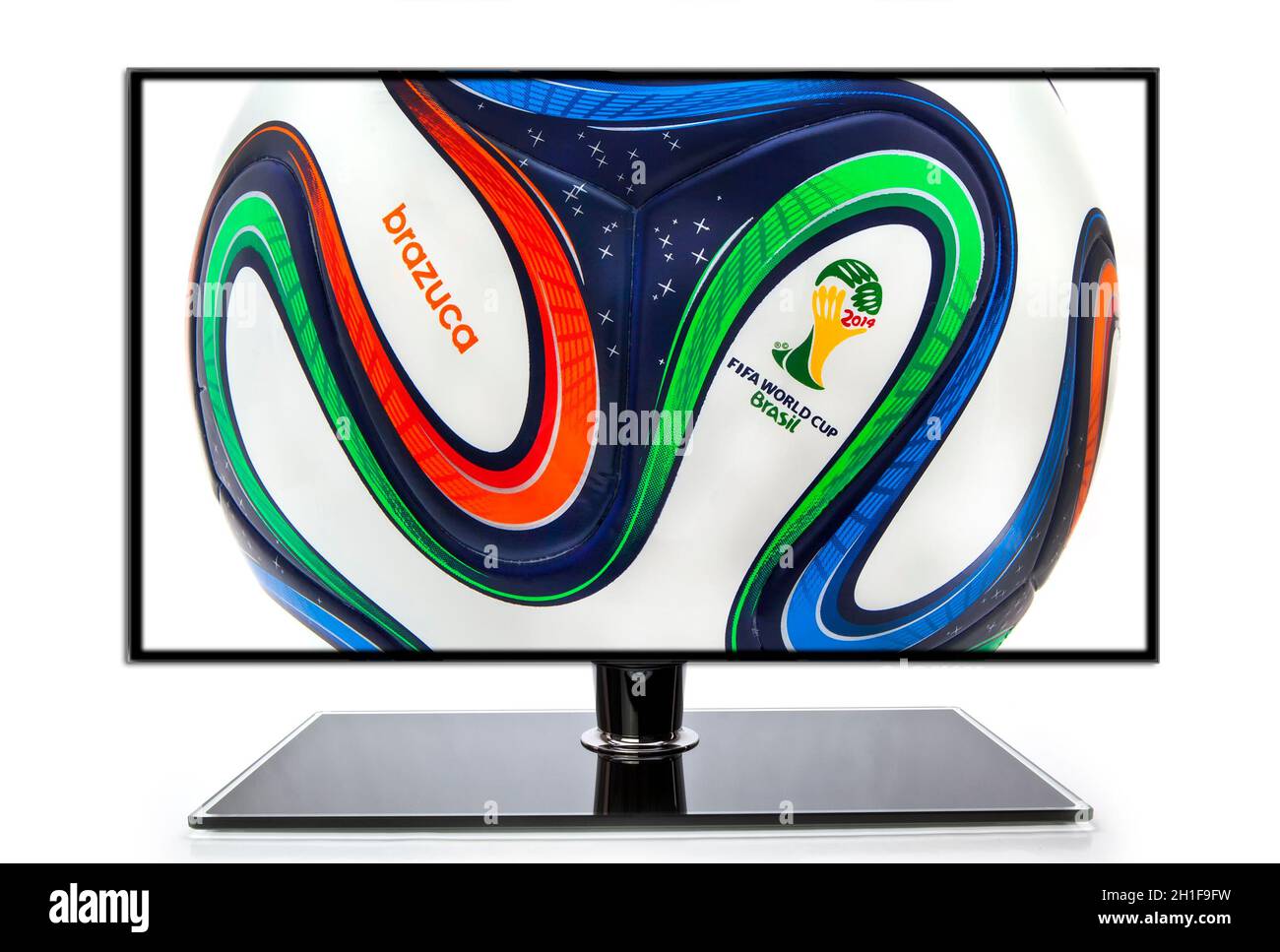 SWINDON, UK - MAY 30, 2014: Adidas Brazuca World Cup 2014 Football, The Official Matchball for the 2014 World Cup with football boots on a TV backgrou Stock Photo