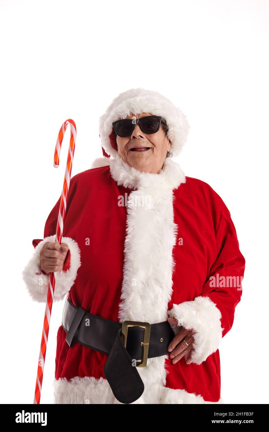 A nonagenarian in a Santa Claus costume with a white background looking at the camera. Stock Photo