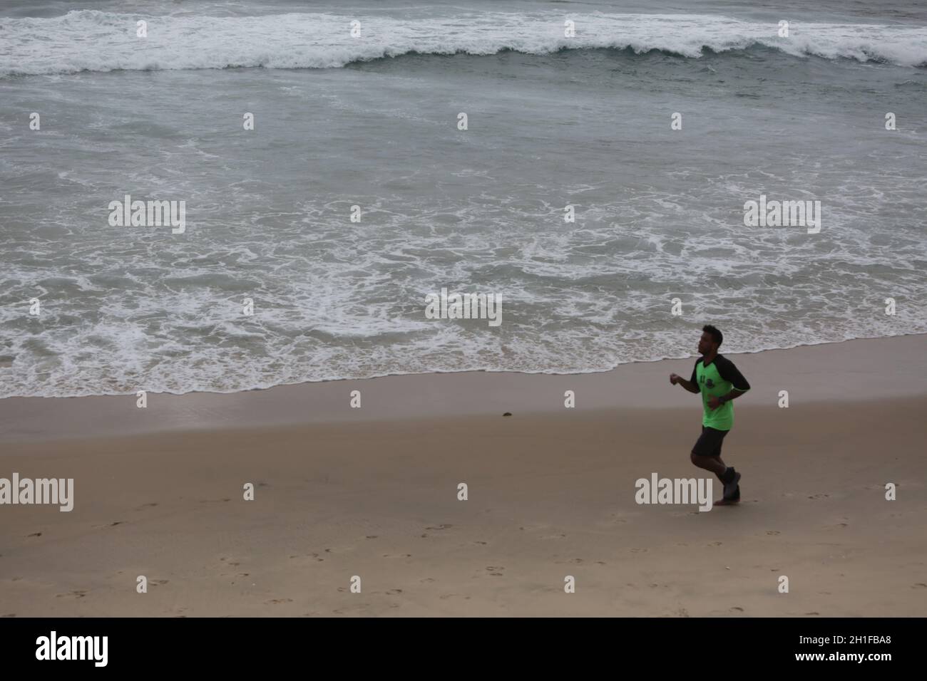 salvador, bahia / brazil - july 10, 2017: Man is seen at the Itapua Mermaid Beach in the city of Salvador. *** Local Caption *** Stock Photo