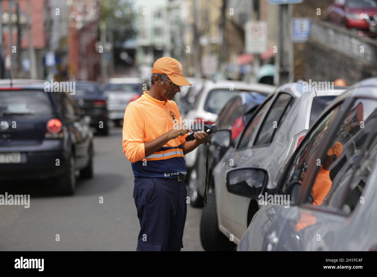 salvador, bahia / brazil - june 3, 2019: Blue Zone Operation Agent is seen charging driver parking fees in the city of Salvador. *** Local Caption *** Stock Photo