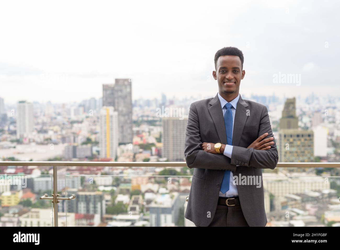 Portrait of handsome young African businessman wearing suit and tie ...