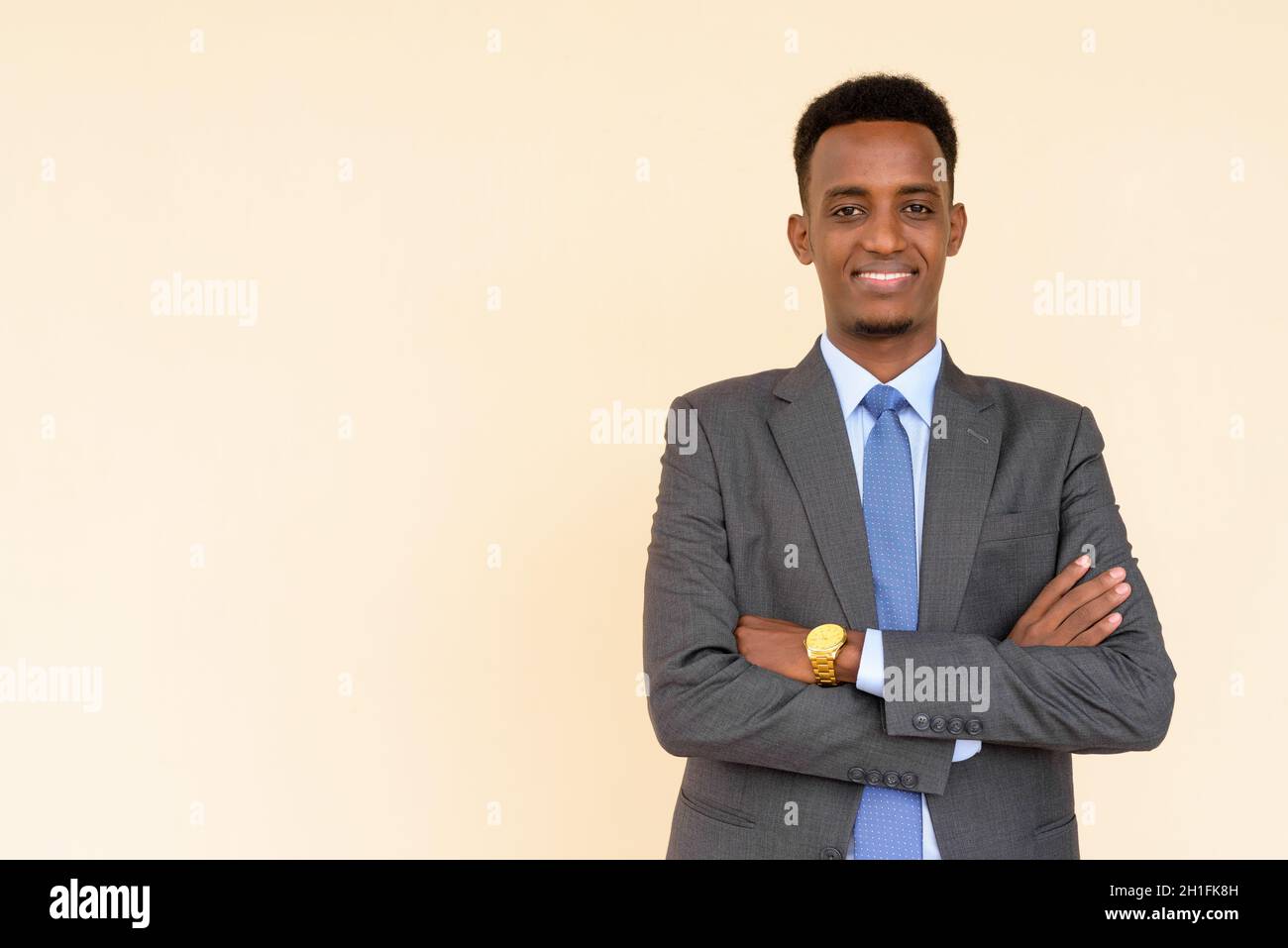 Portrait of handsome young African businessman wearing suit and tie ...