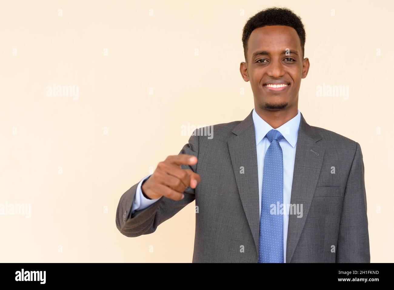 Portrait of handsome young African businessman wearing suit and tie ...