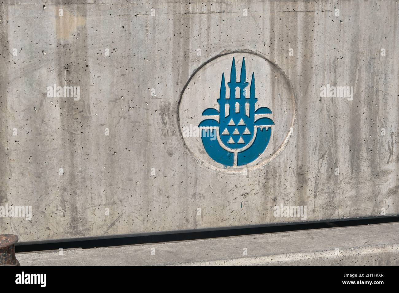 istanbul municipality logo engraved with blue  on concrete wall in Kadikoy shore istanbul. Stock Photo