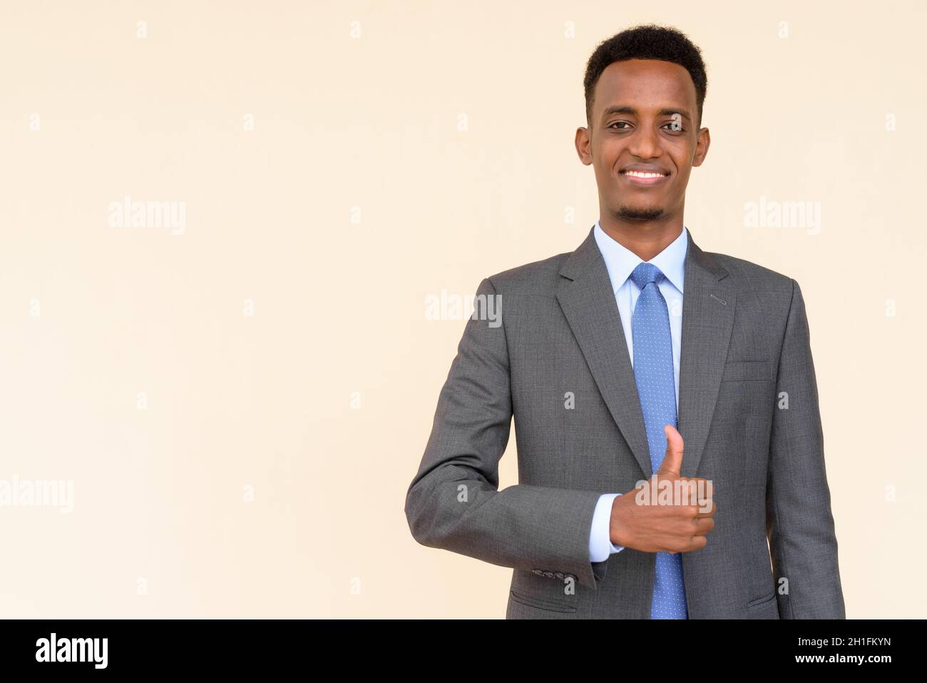 Portrait of handsome young African businessman wearing suit and tie ...
