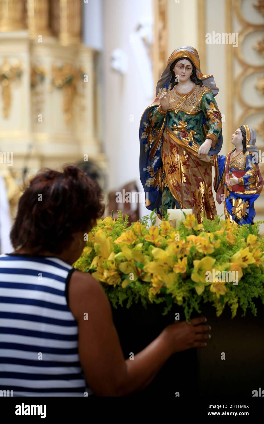 salvador, bahia / brazil - july 24, 2017: devotee of Nossa Senhora Sant’Ana is seen next to the image of the saint in a church in the Nazare neighborh Stock Photo