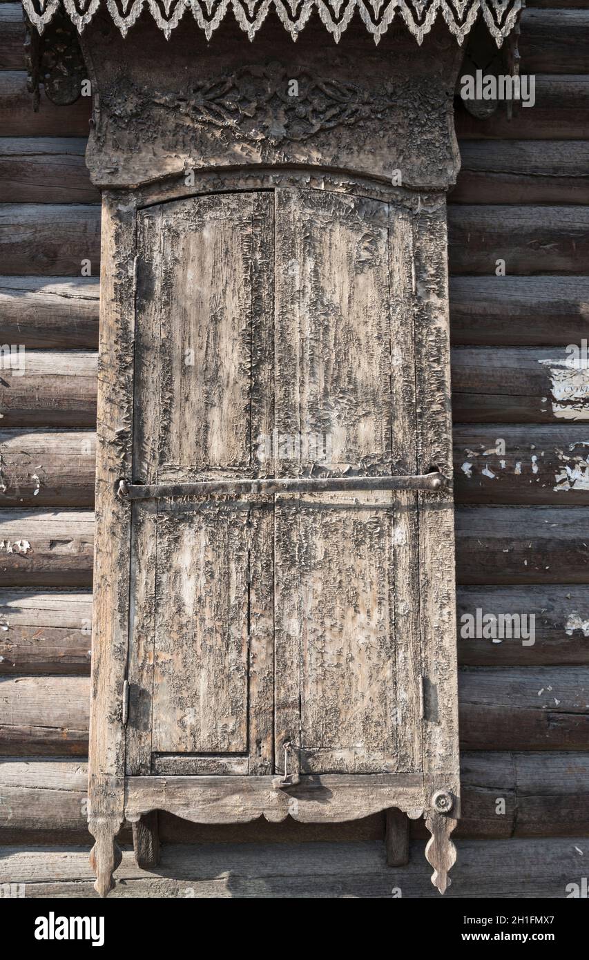 Closed weathered shutter of a traditional wooden house in Ulan-Ude. Republic of Buryatia, Russia Stock Photo