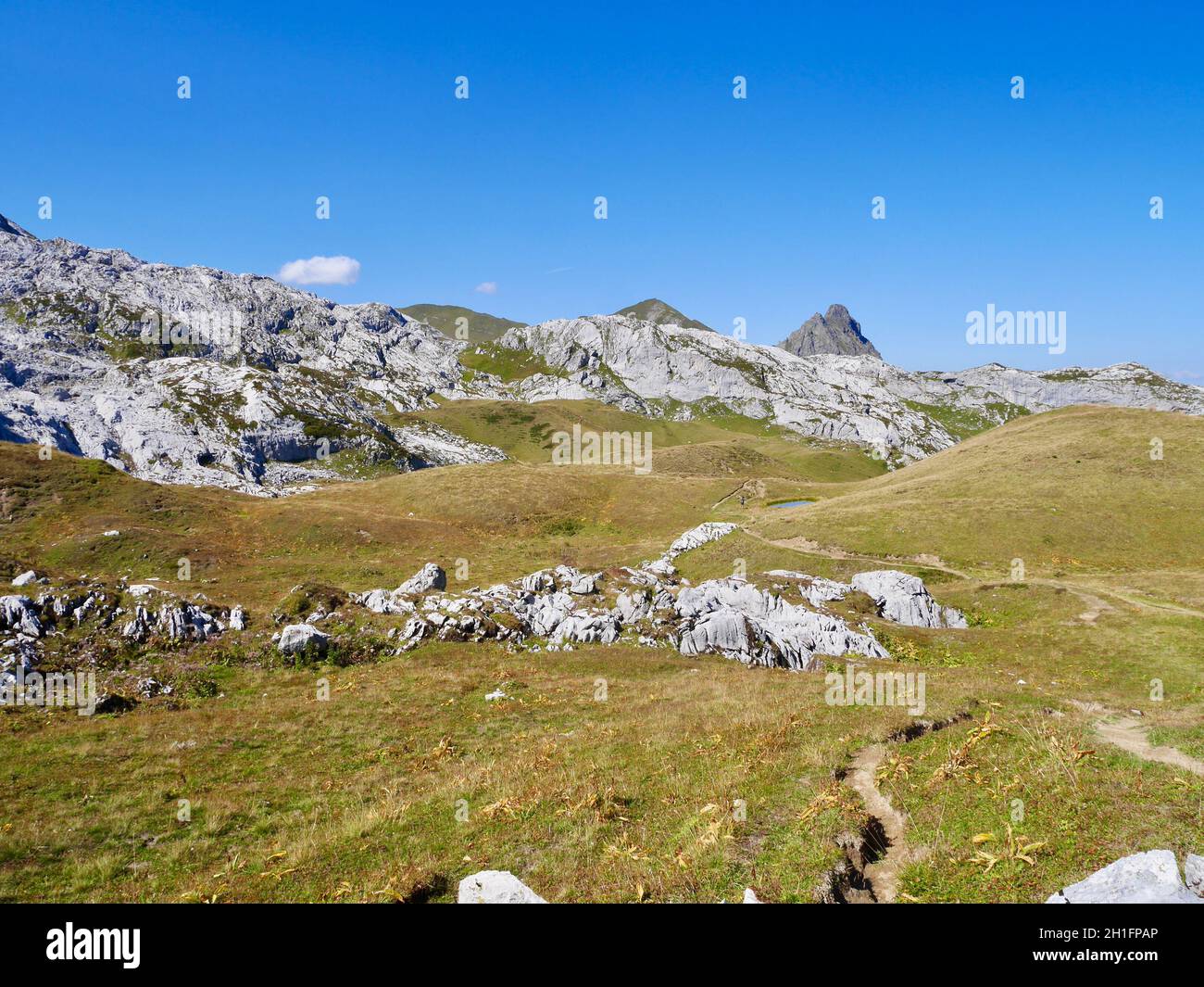 Hiking path winding through alpine landscape in Praettigau, Graubuenden, Switzerland. Stock Photo