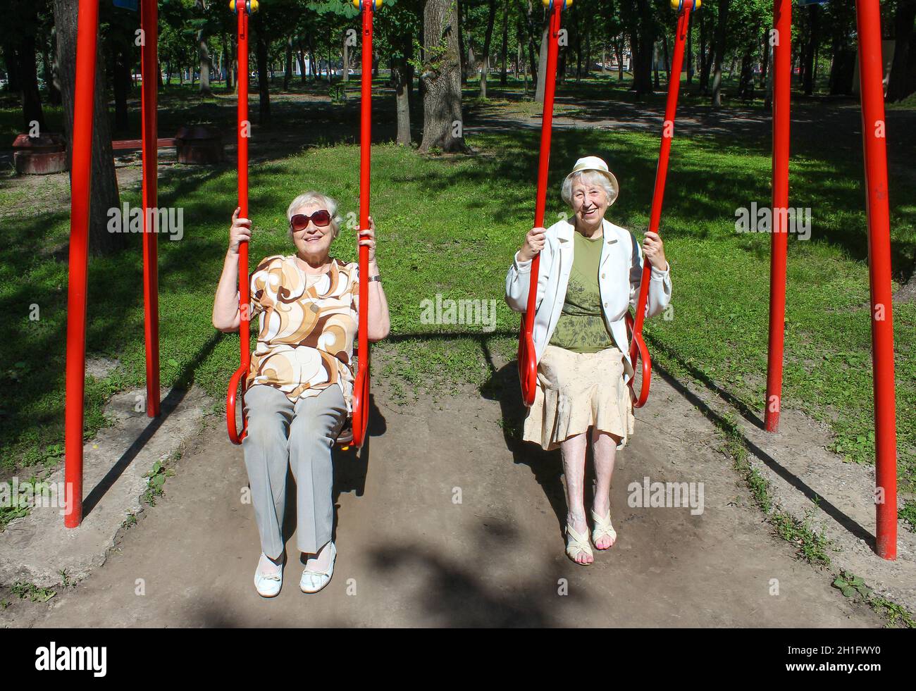 Mature woman swinging in park hi-res stock photography and images - Alamy