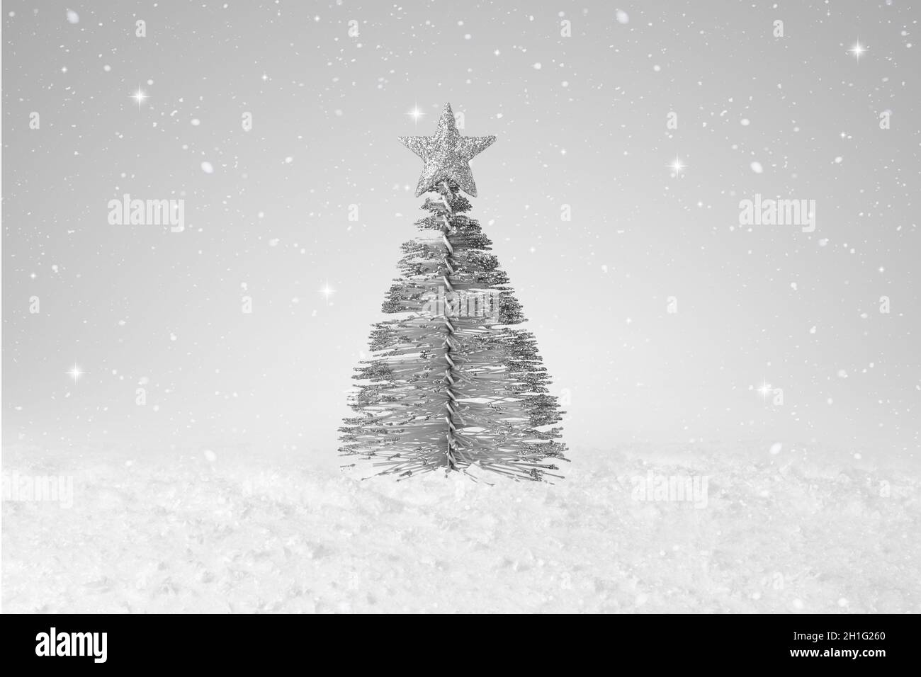 Silver tree shape Christmas Decoration on a fake snow background Stock