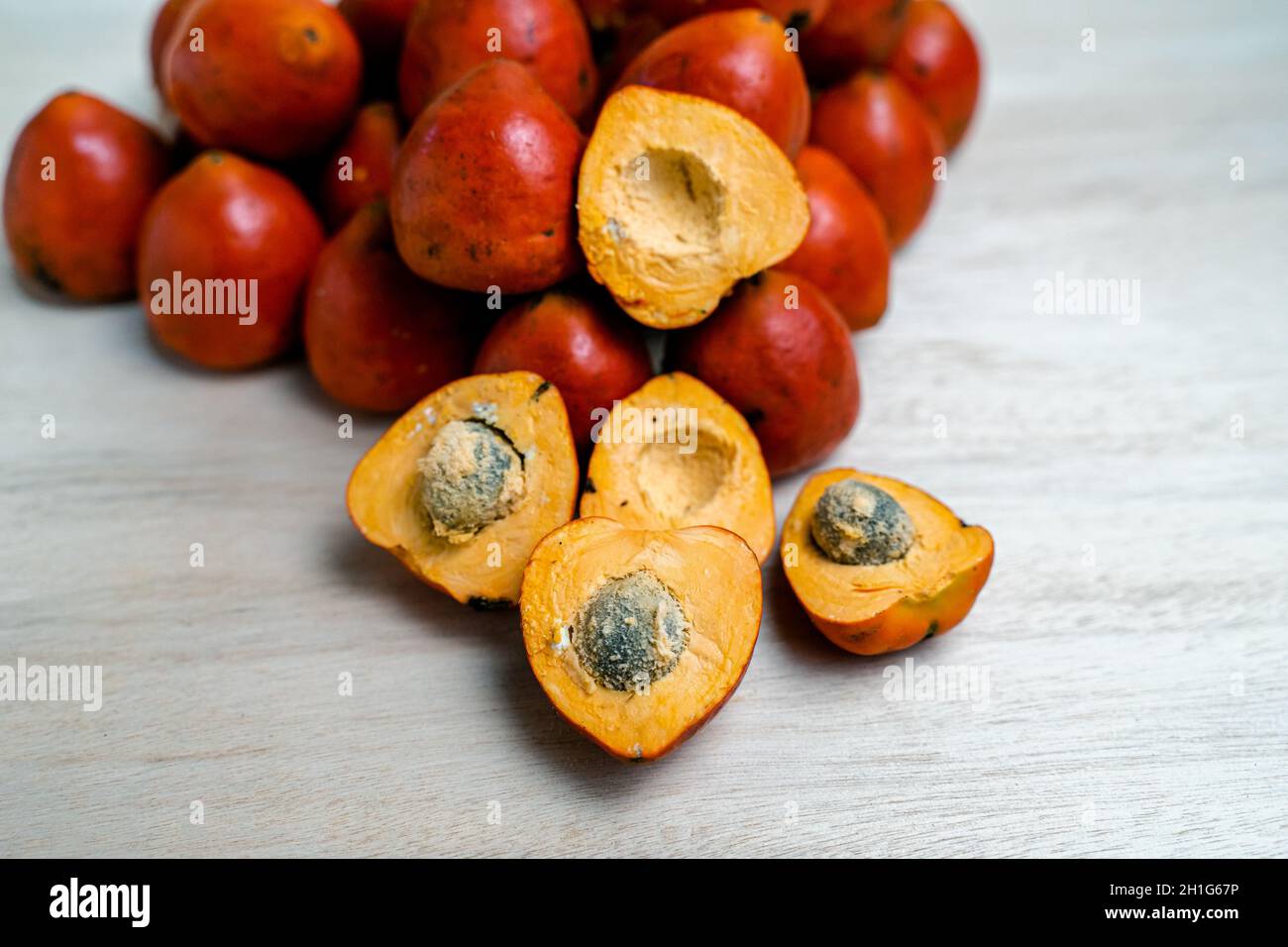 Fruits of chontaduro on the wooden surface Stock Photo